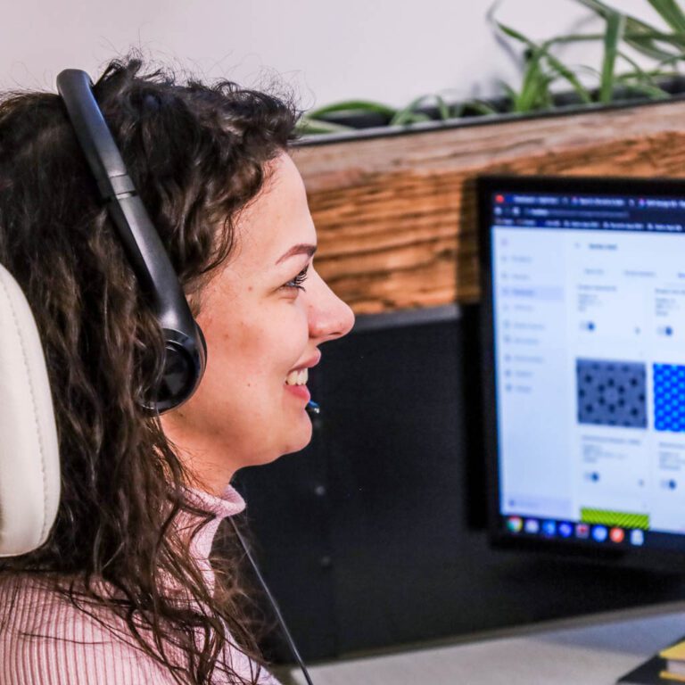 Material Exchange employee in front of monitor